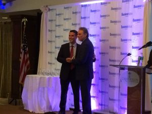 Twomey Latham law firm accepting corporate citizen of the year award